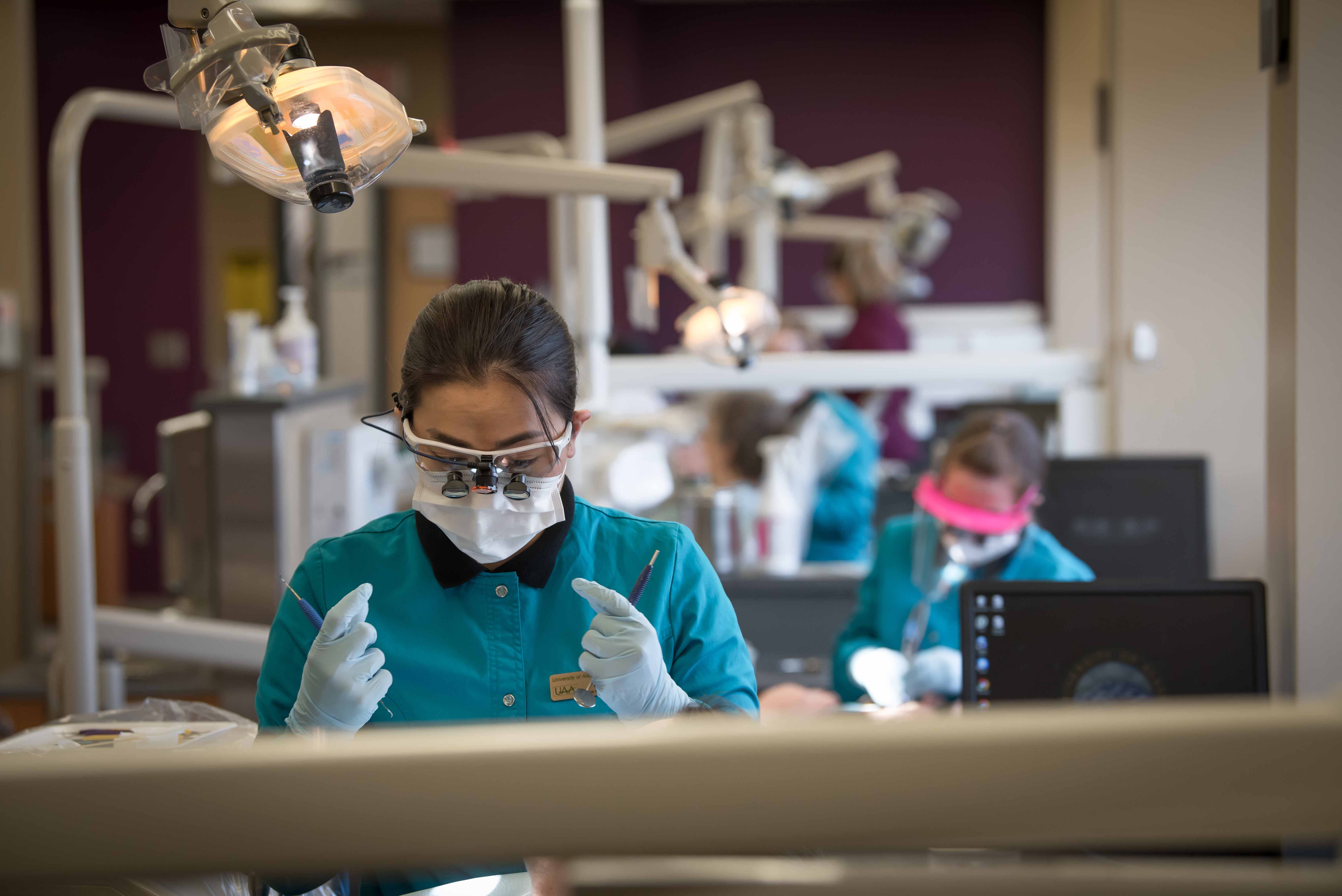 a dental hygine student in the dental clinic